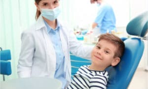 The kid is not afraid to visit his dentist.